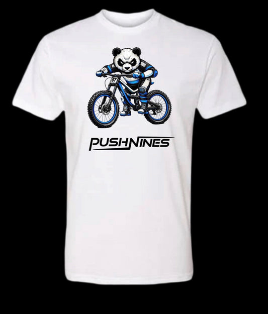 White t-shirt with a panda riding a bike graphic and 'PUSH NINES' text on a black background