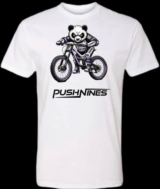 White t-shirt with a panda riding a bike graphic and 'Push Nines' text on a black background